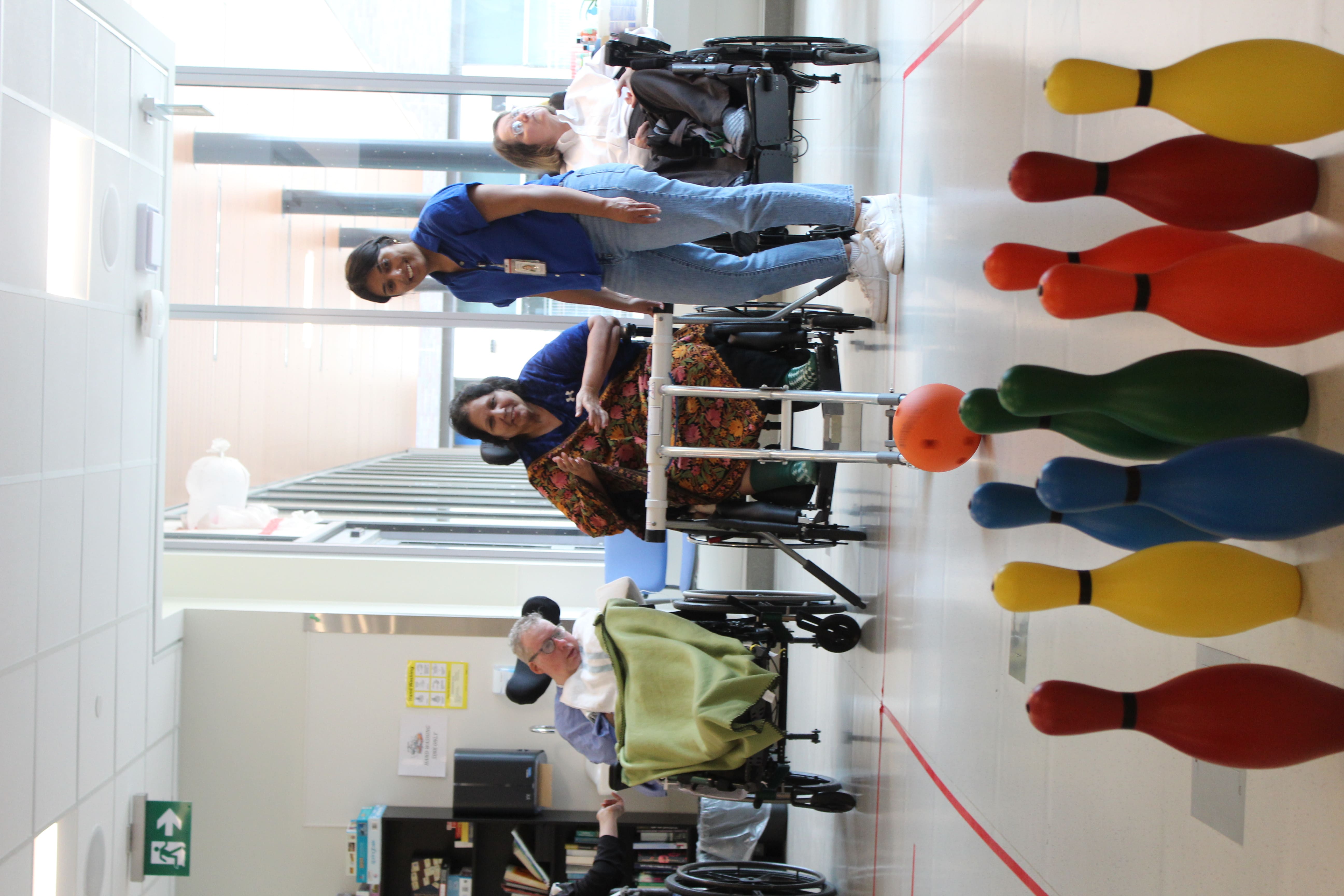 Rachel Armstrong in her wheelchair with a bowling ball. 